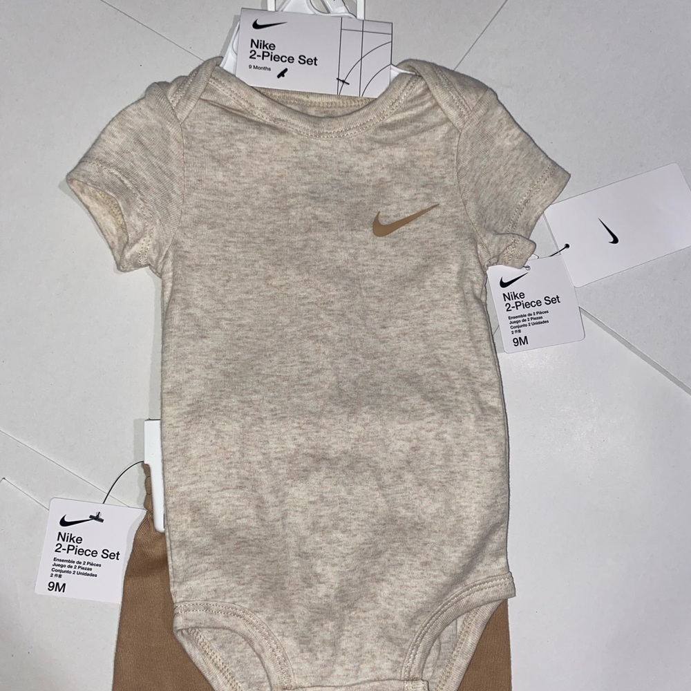 NIKE BABY ONESIE AND PANTS. NEW with tags. Smoke free home. Never worn.